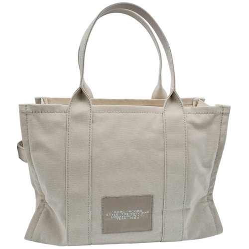 220 - A Marc Jacobs Beige 'The Tote Bag'. Canvas exterior with two handles, and top zip closure. Canvas in... 