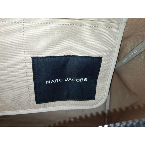 220 - A Marc Jacobs Beige 'The Tote Bag'. Canvas exterior with two handles, and top zip closure. Canvas in... 