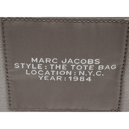 220 - A Marc Jacobs Beige 'The Tote Bag'. Canvas exterior with two handles, and top zip closure. Canvas in... 