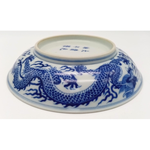 275 - A GUANGXU ERA CHINESE DISH WITH PAINTING OF A 5 CLAWED DRAGON AND NUMBERED ON THE BOTTOM .   17cms D... 