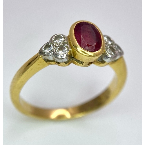 32 - An 18K Yellow Gold Ruby and Diamond Ring. Central oval ruby with six round cut diamond accents. Size... 