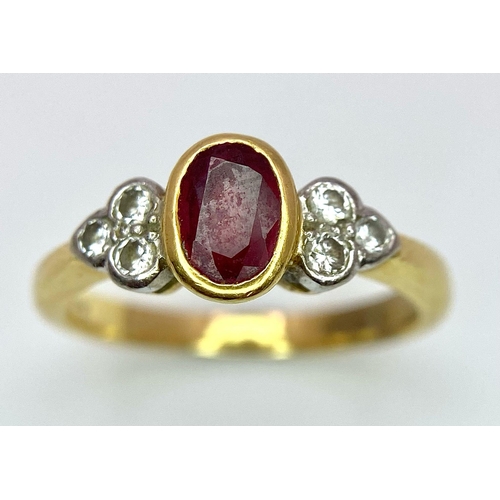 32 - An 18K Yellow Gold Ruby and Diamond Ring. Central oval ruby with six round cut diamond accents. Size... 