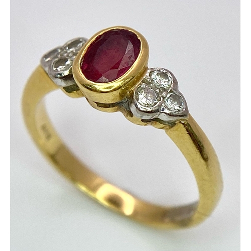 32 - An 18K Yellow Gold Ruby and Diamond Ring. Central oval ruby with six round cut diamond accents. Size... 