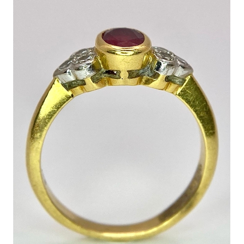 32 - An 18K Yellow Gold Ruby and Diamond Ring. Central oval ruby with six round cut diamond accents. Size... 