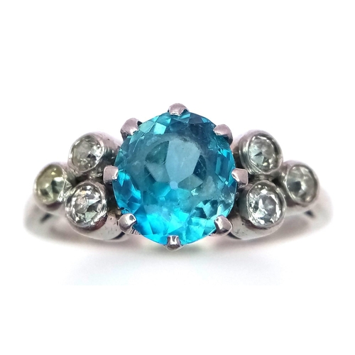 355 - A 9K WHITE GOLD PALLADIUM DIAMOND AND BLUE TOPAZ RING  .   3.2gms   size N