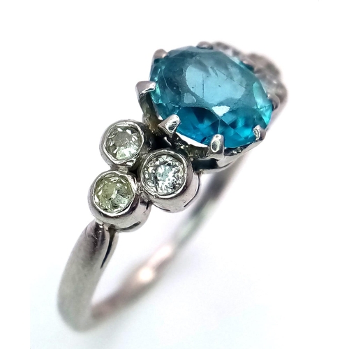 355 - A 9K WHITE GOLD PALLADIUM DIAMOND AND BLUE TOPAZ RING  .   3.2gms   size N