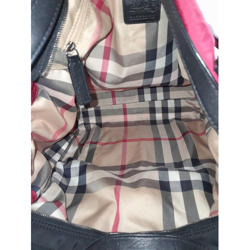 374 - A Burberry Red 'Buckleigh' Tote Bag. Textile exterior with black leather details, black and chrome t... 