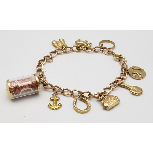 380 - A 9K Gold Charm Bracelet. 10 charms including: 10 shilling note, handbag and binoculars! 18cm length... 