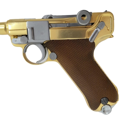 500 - A golden LUGER semi-automatic gas powered pistol. This is an exact replica of the real thing, firing... 