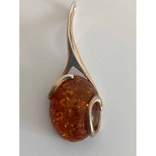 629 - AMBER CABOCHON PENDANT Mounted in SILVER. 4.5 cm drop.