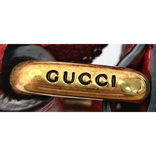 74 - A Gucci Red Logo Shoulder Bag. Leather exterior with gold-toned hardware, adjustable strap and zippe... 