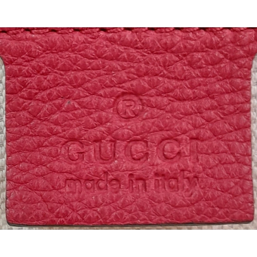 74 - A Gucci Red Logo Shoulder Bag. Leather exterior with gold-toned hardware, adjustable strap and zippe... 