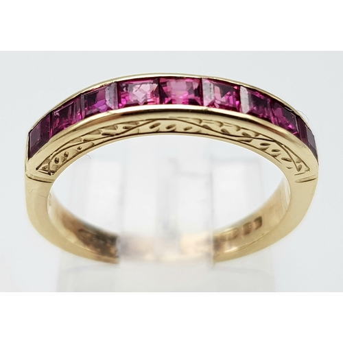 810 - A 9K GOLD CHANNEL SET RUBY BAND RING .  2.5gms   size J