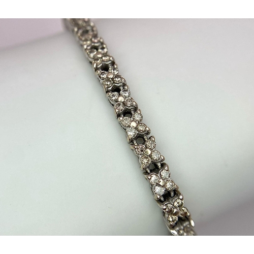 147 - An 18K White Gold Diamond Tennis Bracelet. 160 small round cut diamonds - 1.5ctw approx. 18cm length... 