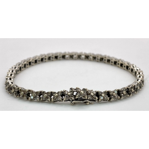 147 - An 18K White Gold Diamond Tennis Bracelet. 160 small round cut diamonds - 1.5ctw approx. 18cm length... 