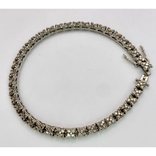 147 - An 18K White Gold Diamond Tennis Bracelet. 160 small round cut diamonds - 1.5ctw approx. 18cm length... 