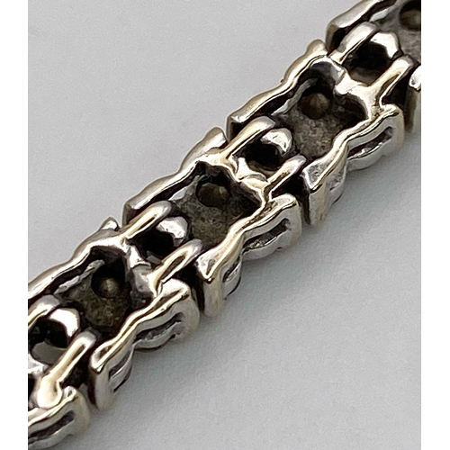 147 - An 18K White Gold Diamond Tennis Bracelet. 160 small round cut diamonds - 1.5ctw approx. 18cm length... 