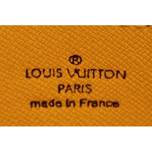 164 - A Louis Vuitton Vanilla Wallet. Epi leather exterior gold-toned hardware and zipped top closure. Yel... 