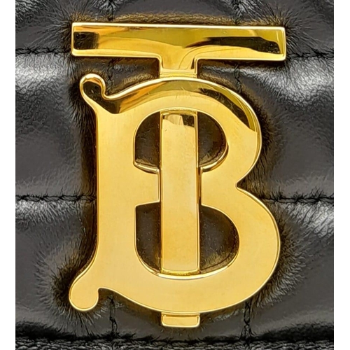 185 - A Burberry Black 'Lola' Backpack. Quilted leather exterior with gold-toned hardware, chain and leath... 