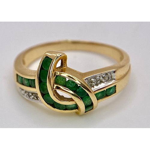 193 - A 14K GOLD DIAMOND AND EMERALD RING .   3.3gms   size O