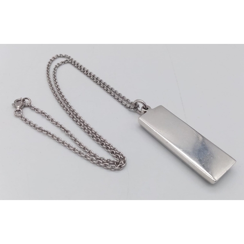 216 - A SOLID SILVER INGOT ON A 40cms SILVER CHAIN .  37.1gms