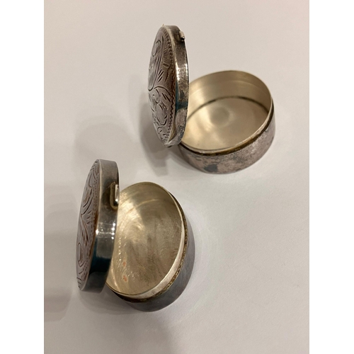 755 - 2 x Vintage SILVER PILL BOXES. To include oval and round shapes. Both having decorated lids and full... 