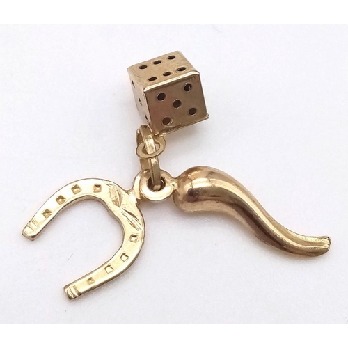 1021 - A 9K YELLOW GOLD GOOD LUCK CHARM WITH HORSESHOE, HORN OF PLENTY/LIFE AND DICE 0.8G

SC 4014