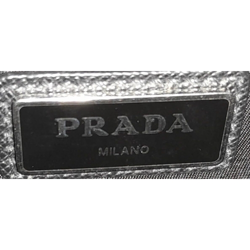 124 - A Prada Black 'Tessuto Montagna' Crossbody Bag. Textile exterior with silver-toned hardware, a padde... 