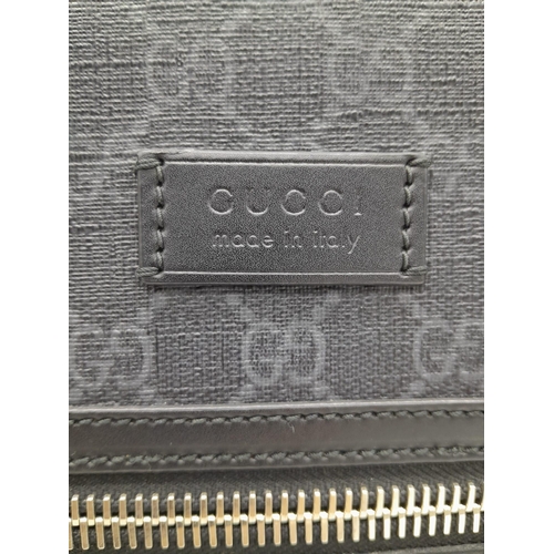 171 - A Gucci Monogram Night Courier Messenger Bag. Leather exterior with patch details, silver-toned hard... 