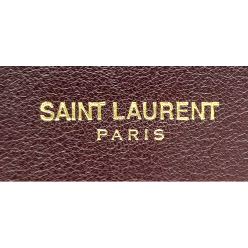 95 - A Saint Laurent Sac De Jour Burgundy Handbag. Leather Exterior, Gold Tone Hardware, Double Handle in... 