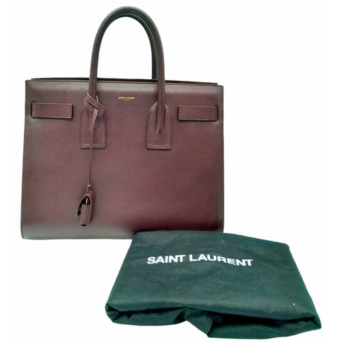 95 - A Saint Laurent Sac De Jour Burgundy Handbag. Leather Exterior, Gold Tone Hardware, Double Handle in... 