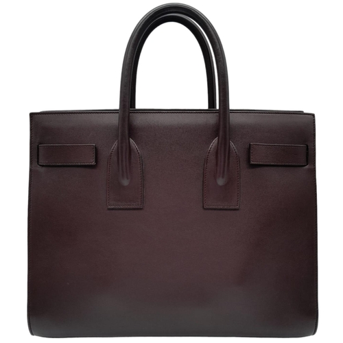 95 - A Saint Laurent Sac De Jour Burgundy Handbag. Leather Exterior, Gold Tone Hardware, Double Handle in... 