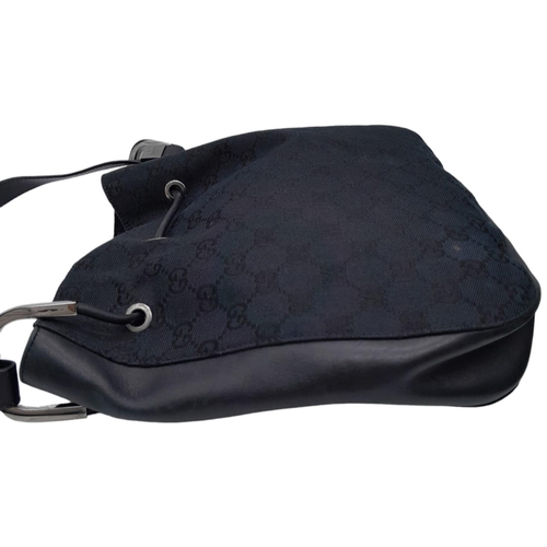 206 - A Gucci Black Monogram Drawstring Shoulder Bag. Canvas exterior with silver-toned hardware, leather ... 