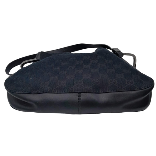 206 - A Gucci Black Monogram Drawstring Shoulder Bag. Canvas exterior with silver-toned hardware, leather ... 