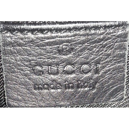 206 - A Gucci Black Monogram Drawstring Shoulder Bag. Canvas exterior with silver-toned hardware, leather ... 