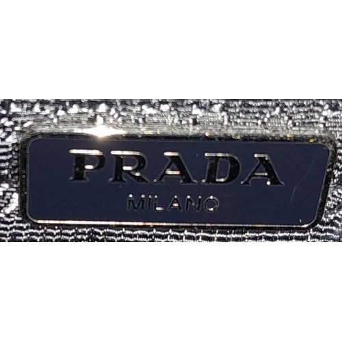 260 - A Prada Navy Blue Mini Backpack. Textile exterior with silver-toned hardware, leather top handle, tw... 