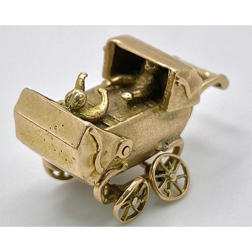 369 - A 9K GOLD PRAM CHARM WITH MOVING PARTS .    4gms