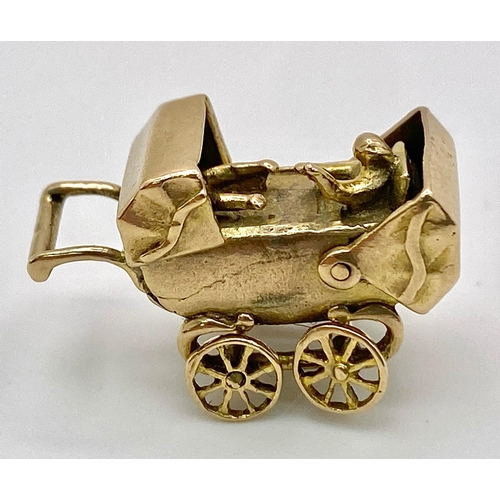 369 - A 9K GOLD PRAM CHARM WITH MOVING PARTS .    4gms