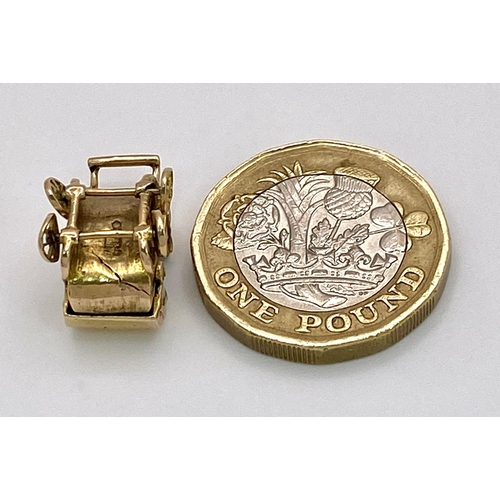 369 - A 9K GOLD PRAM CHARM WITH MOVING PARTS .    4gms