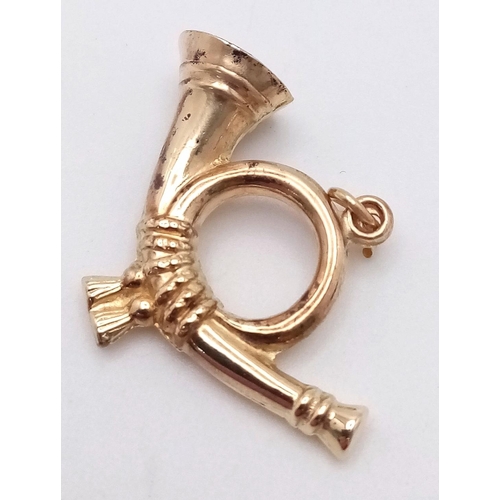 909 - A 9K GOLD BUGLE CHARM .   1.3gms