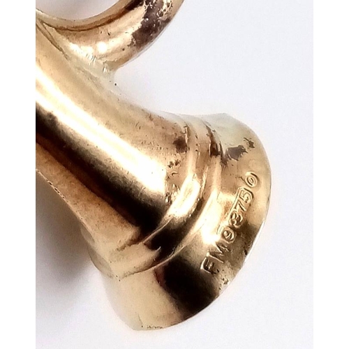 909 - A 9K GOLD BUGLE CHARM .   1.3gms