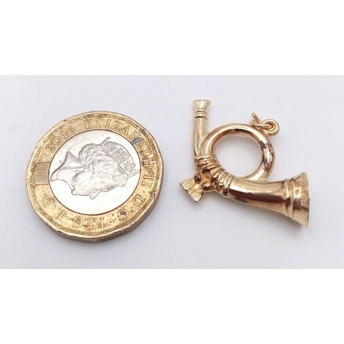 909 - A 9K GOLD BUGLE CHARM .   1.3gms