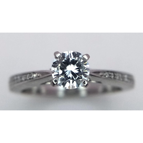 452 - A PLATINUM DIAMOND SOLITAIRE RING 0.50CT ROUND BRILIANT CUT MAIN STONE WITH ADDITIONAL DIAMOND SHOUL... 