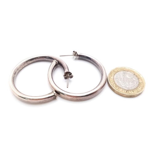 991 - A vintage pair of sterling silver hoop earrings. Total weight 9.85G.