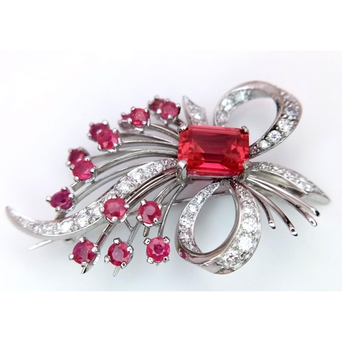 1025 - A STUNNING DIAMOND AND RUBY BROOCH SET IN PLATINUM , A MAJESTIC SPRAY OF RUBIES EMINATING FROM A DIA... 