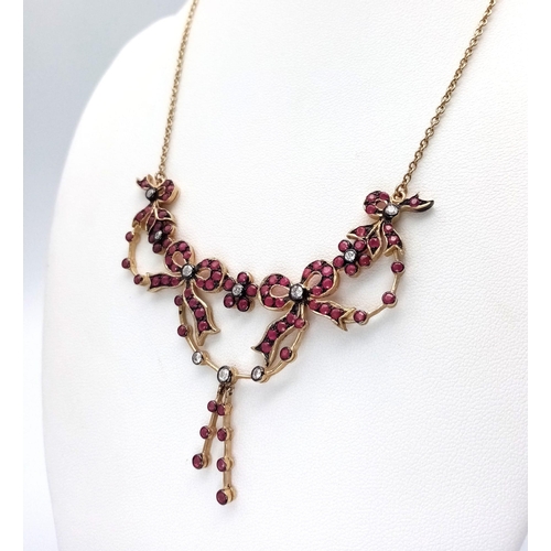 1208 - An Art Deco Style 9K Yellow Gold Ruby and Diamond Lavaliere Necklace. Floral and bow decoration. 40c... 