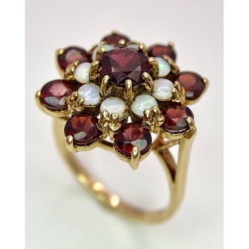 1044 - A GARNET AND OPAL CLUSTER RING SET IN 9K GOLD .2.7gms   size P