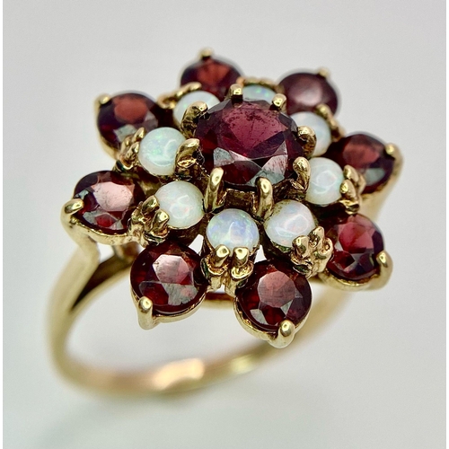 1044 - A GARNET AND OPAL CLUSTER RING SET IN 9K GOLD .2.7gms   size P