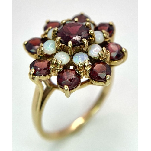 1044 - A GARNET AND OPAL CLUSTER RING SET IN 9K GOLD .2.7gms   size P