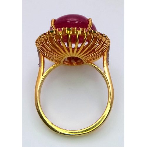 829 - A Ruby Cabochon Ring with a Halo of Tourmalines and Diamonds on 925 Silver. Approximately 10ct ruby,... 